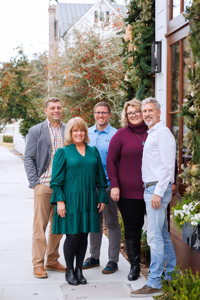 ACRE agents posed in front of a historic Old Village doorway.